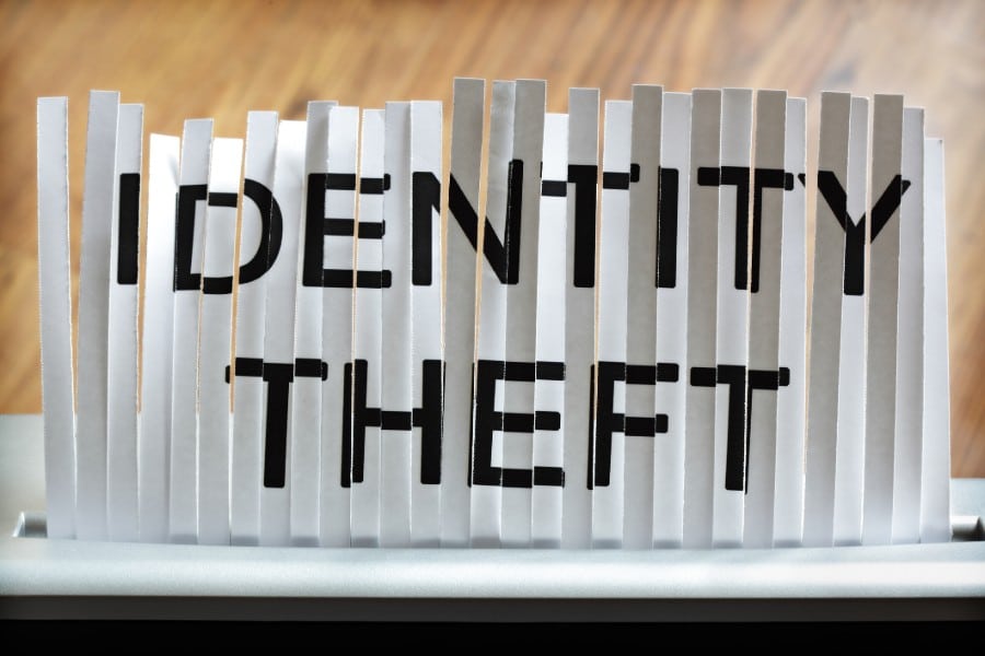 A shredded document that read identity theft is put through a shredder again for extra security