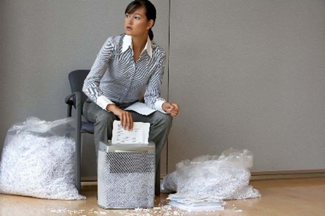 Office woman shredding documents