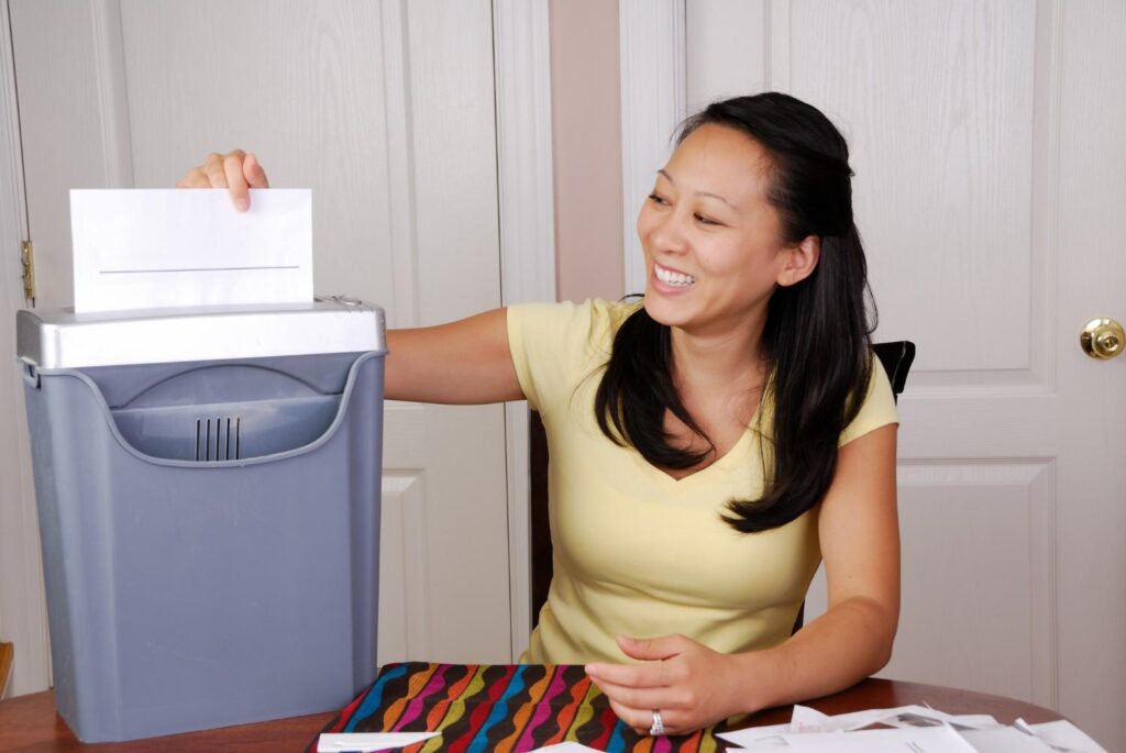 Hybrid model company Employee working from home shredding paper in Lubbock, TX