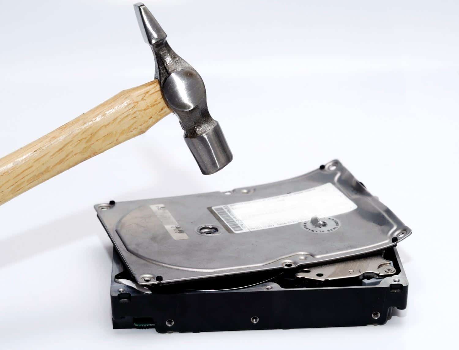 Data Destruction Services in Lubbock, TX, showing a hard drive being destroyed with a hammer for secure data removal.