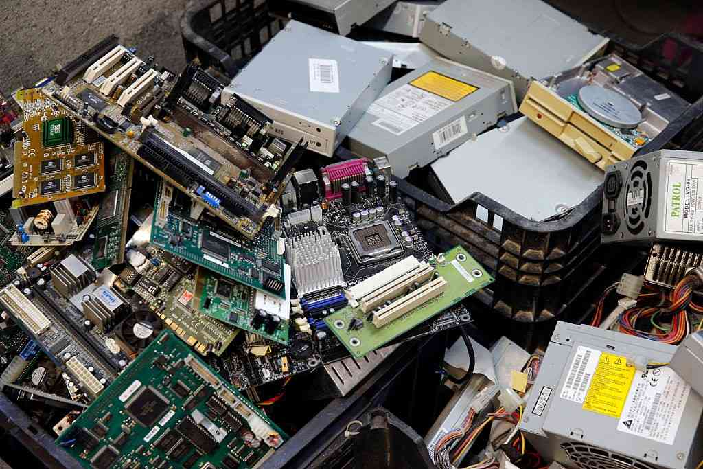 Pile of discarded computer parts and circuit boards showing e-waste risks from improper disposal in Lubbock, TX.